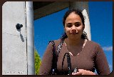 Photograph of  women with a SoundPost and base station above her shoulder